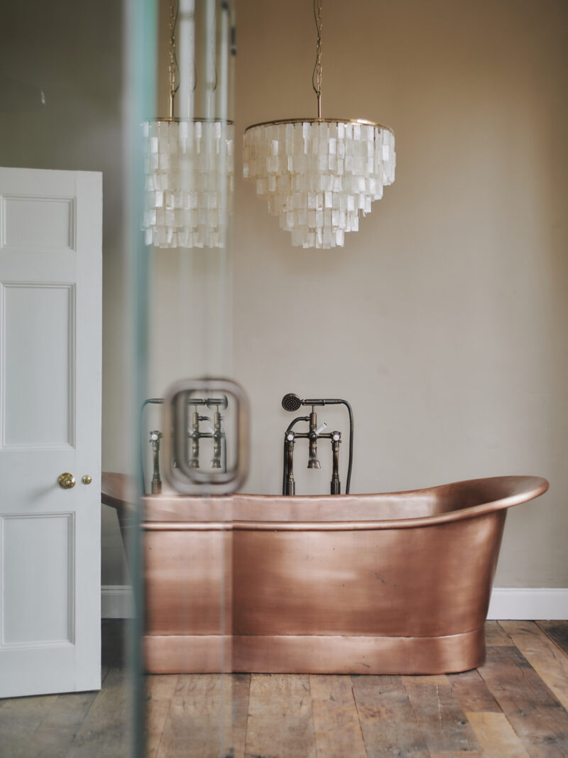 Cotswold luxury holiday home copper bath tub and chandelier