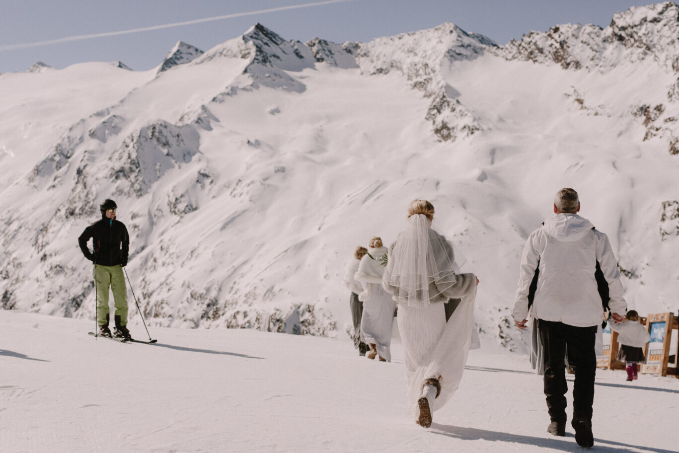 Bride walking to her wedding on top of mountain in Austria