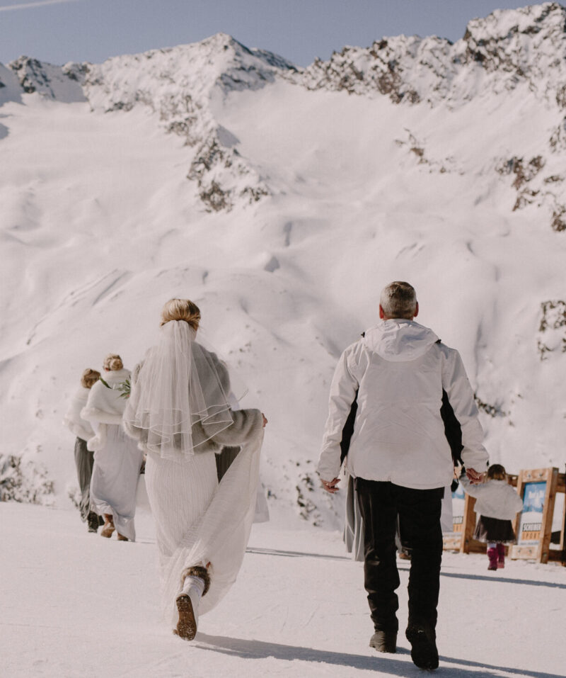 Bride walking to her wedding on top of mountain in Austria