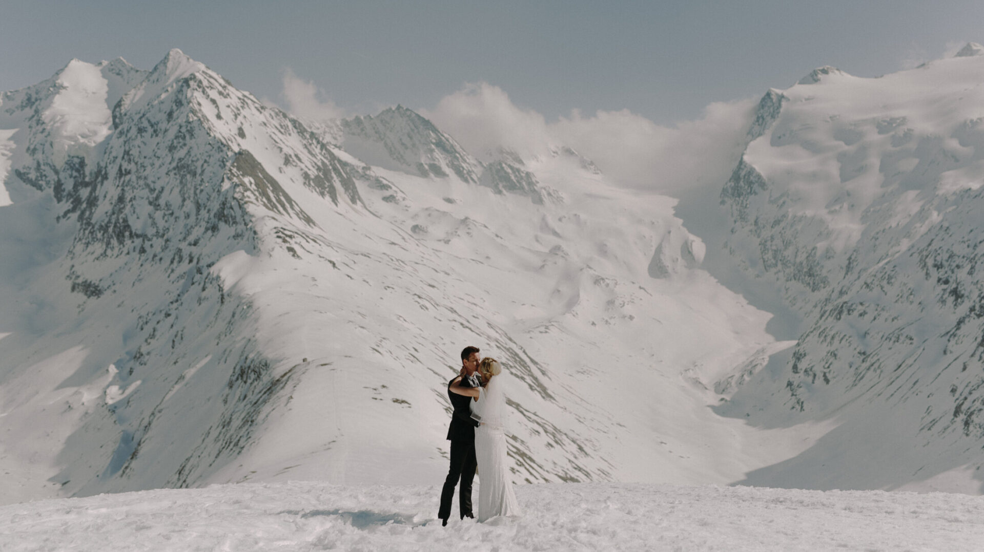 Bride and groom stood on top of a mountain for mountain weddings