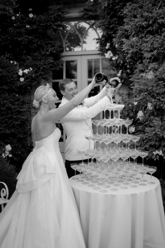 Bridge and Groom pouring champagne at Euridge Manor Wedding venue