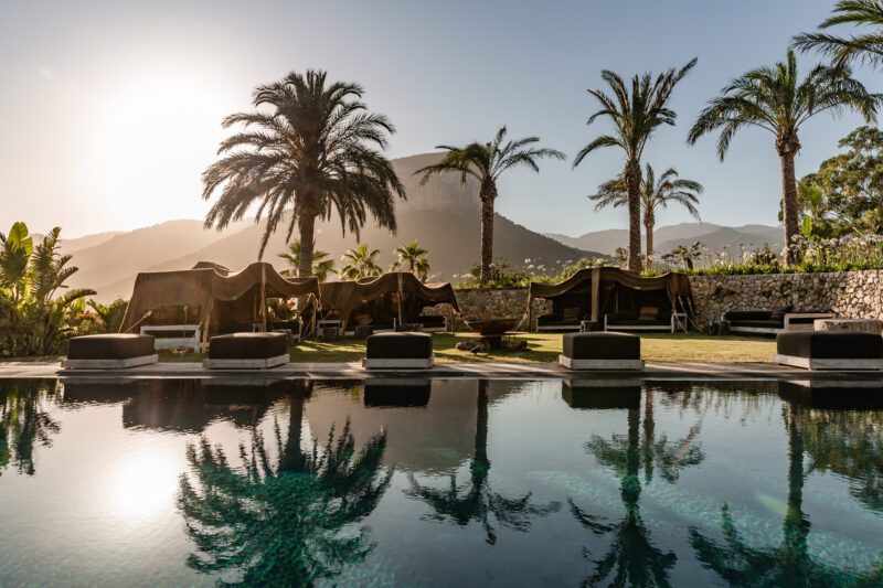 luxury catering retreat with swimming pool with mountains and palm trees in the background
